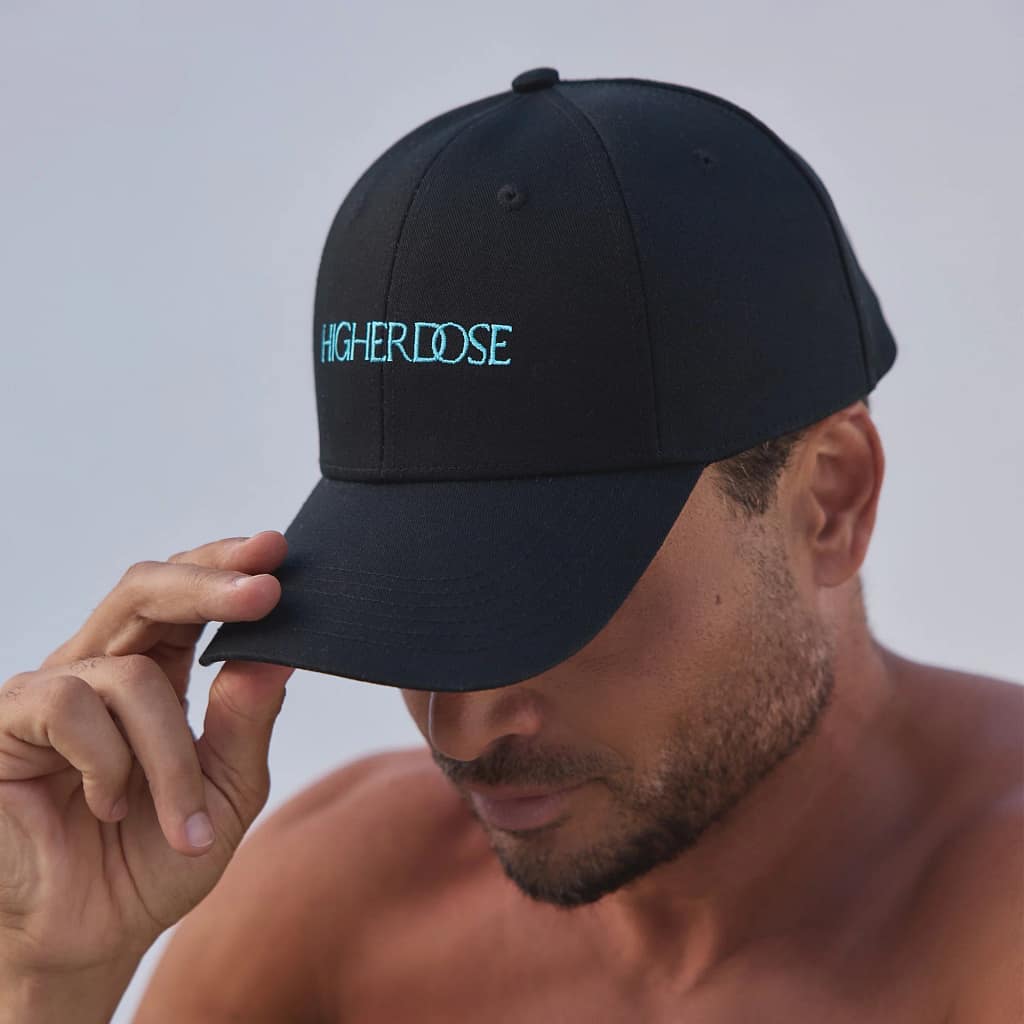 Man using HigherDose Red Light Therapy Hat with wireless freedom of movement during treatment