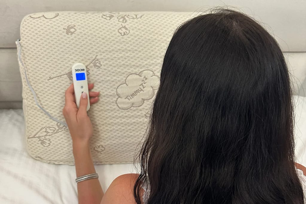 Woman setting a program on the Sedona TimmyZzz controller before sleep