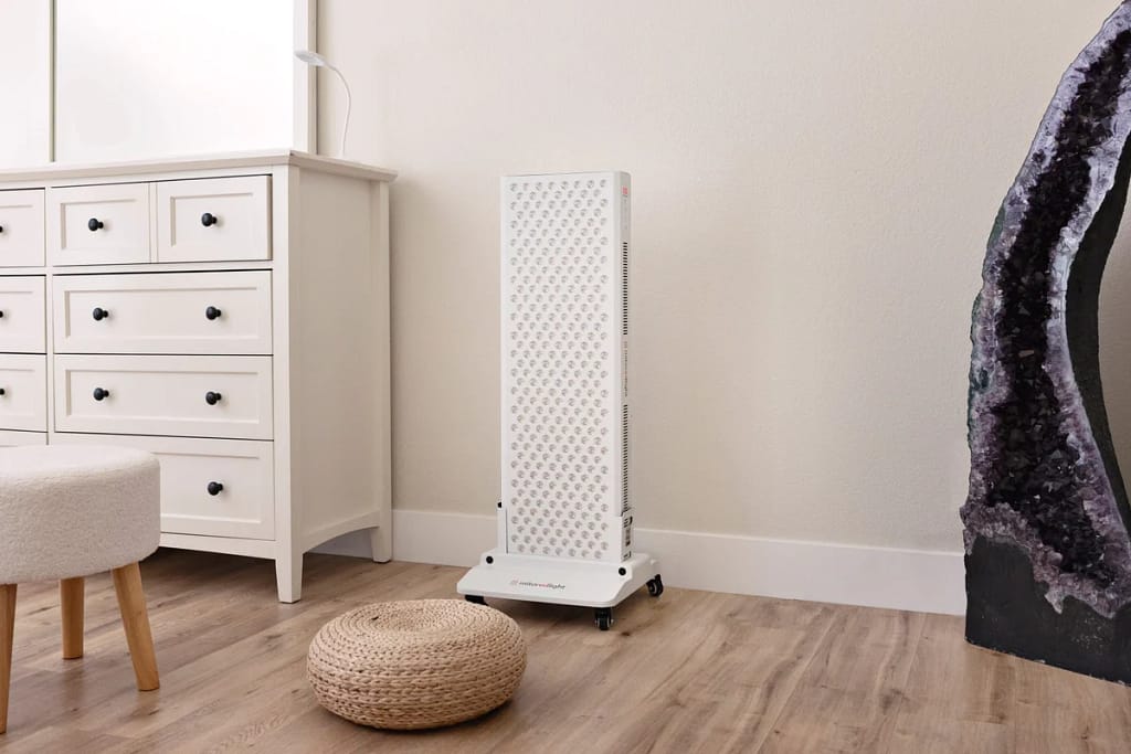 MitoPRO 1500+ Mito red light panel standing on its vertical floor stand in a room