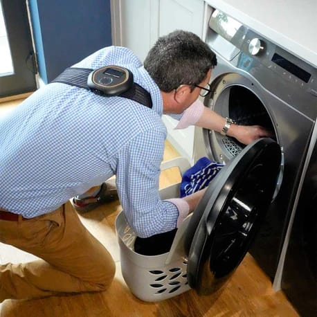 Celler8 wearable positioned on upper back while doing laundry