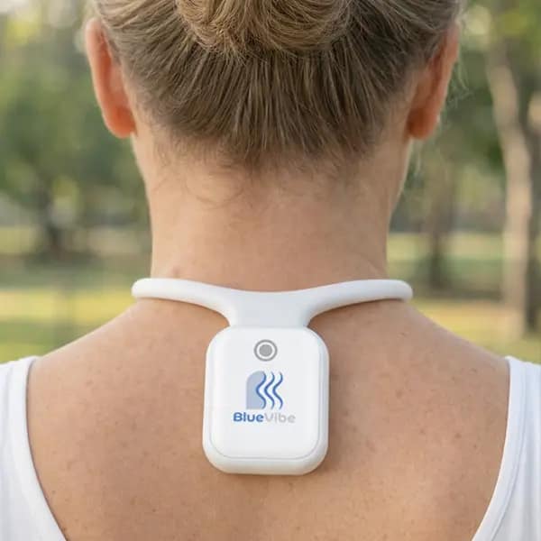 Resona BlueVibe Review: closeup of the 40Hz wearable on the back of a woman's neck