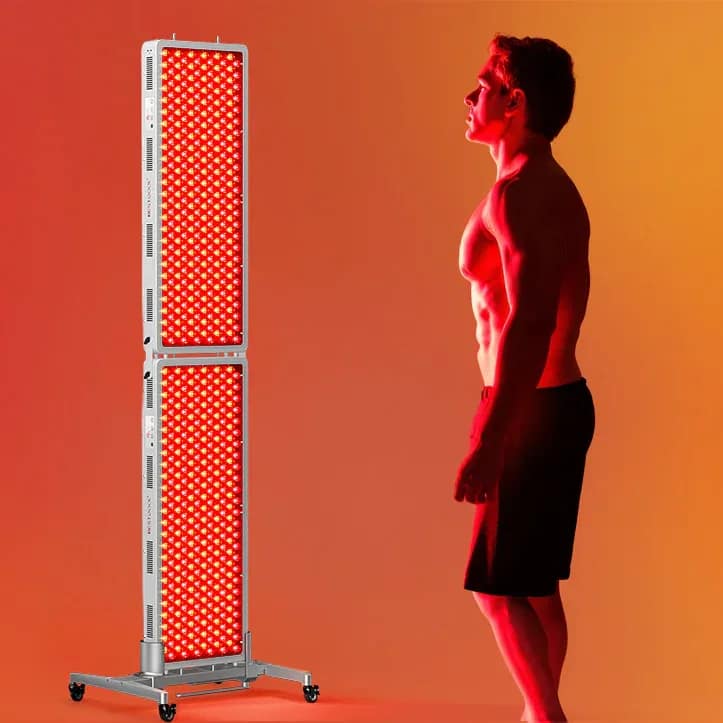 Man using BestQool PRO 300 for front body near-infrared light therapy session at home