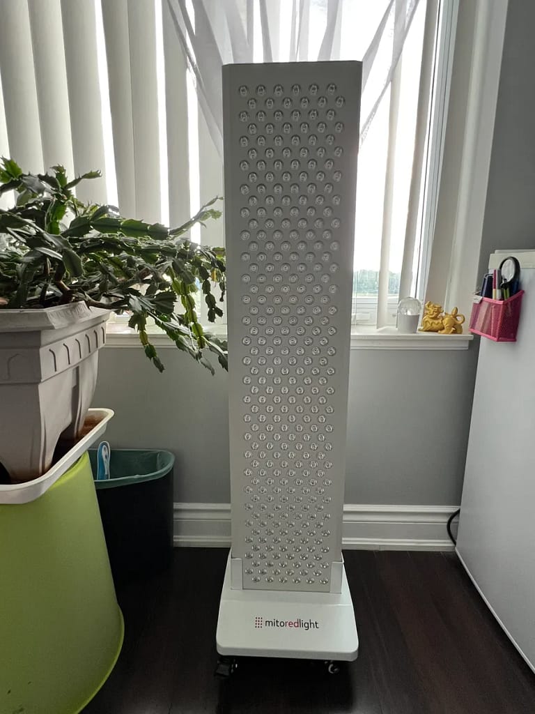 MitoPRO 1500+ mito panel on its vertical stand, lights off, in front of a living room window