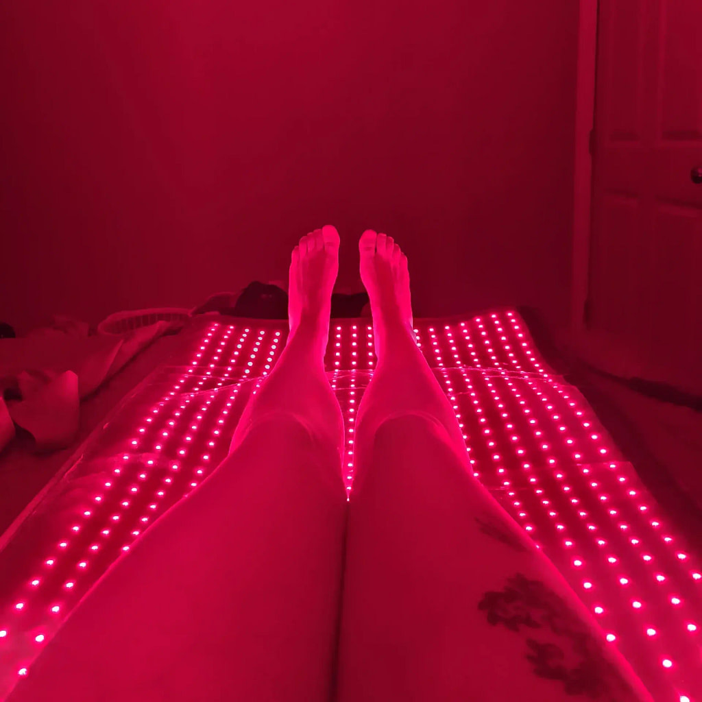 Woman's legs on LifePro LED Mat showing targeted lower body red light therapy application