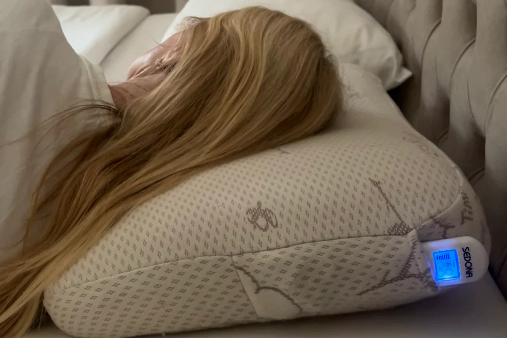 Woman sleeping on the Sedona TimmyZzz PEMF Pillow for deeper rest