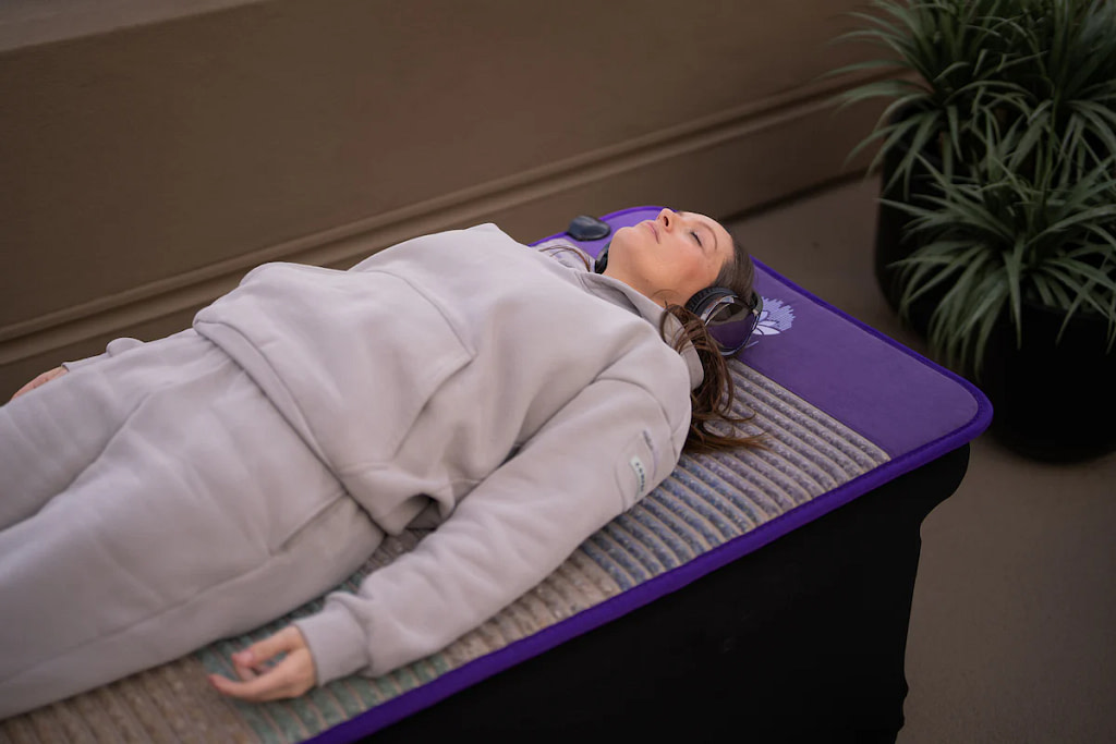 User enjoying a PEMF session on the Align Zen Mat for deep relaxation