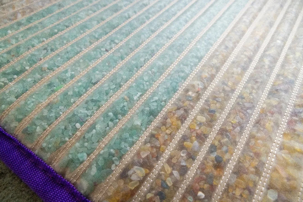 Detailed surface showing green aventurine and yellow agate crystals for chakra balancing