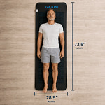 Man lying on the Grooni mat, with dimensions