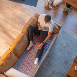 Man relaxing on a sofa with the healthyline TAJ
