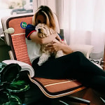 Young woman and dog resting on lounge chair with HealthyLine TAO PEMF Chair Mat for cozy relaxation