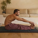 Man stretching on the HigherDose PEMF mat