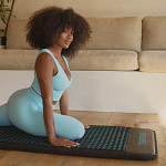 Woman doing a yoga session on the HighrDOSE mat