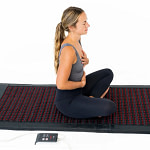 Woman seating on the Hooga PEMF mat