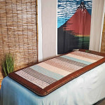 Phymat PEMF mat placed on bed, ready for home PEMF therapy