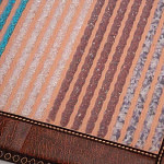 Close-up detail of Phymat Gemstones PEMF mat surface showing colorful gemstones and texture