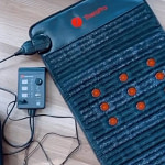 Therasage TheraPro PEMF Mat and controller on the ground – wellness setup for full-body PEMF therapy