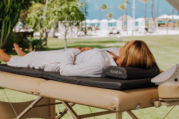 Woman using Sedona Pro PEMF Mat outdoors for relaxation