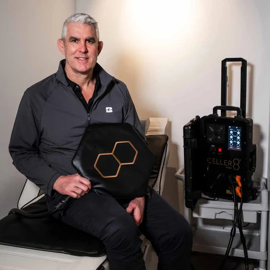 Celler8 MAX Review: man using the pad applicator on his lap beside the main unit