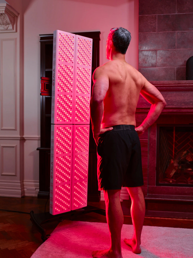 Man receiving full-body photobiomodulation treatment with Kala Elite QUAD panel