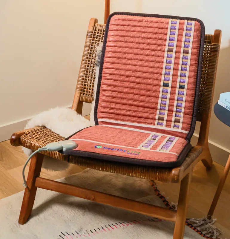 TAO PEMF Chair Mat positioned on standard chair for everyday use and pain relief at home or office