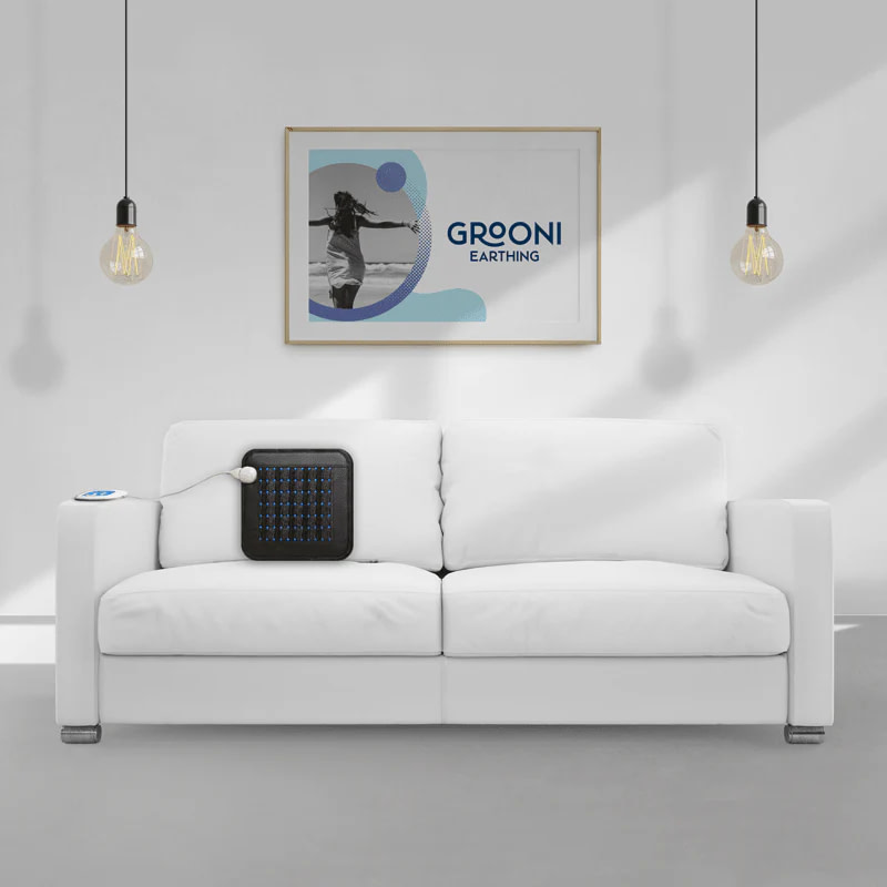 Grooni Earthing PEMF Pad resting on couch for home therapy