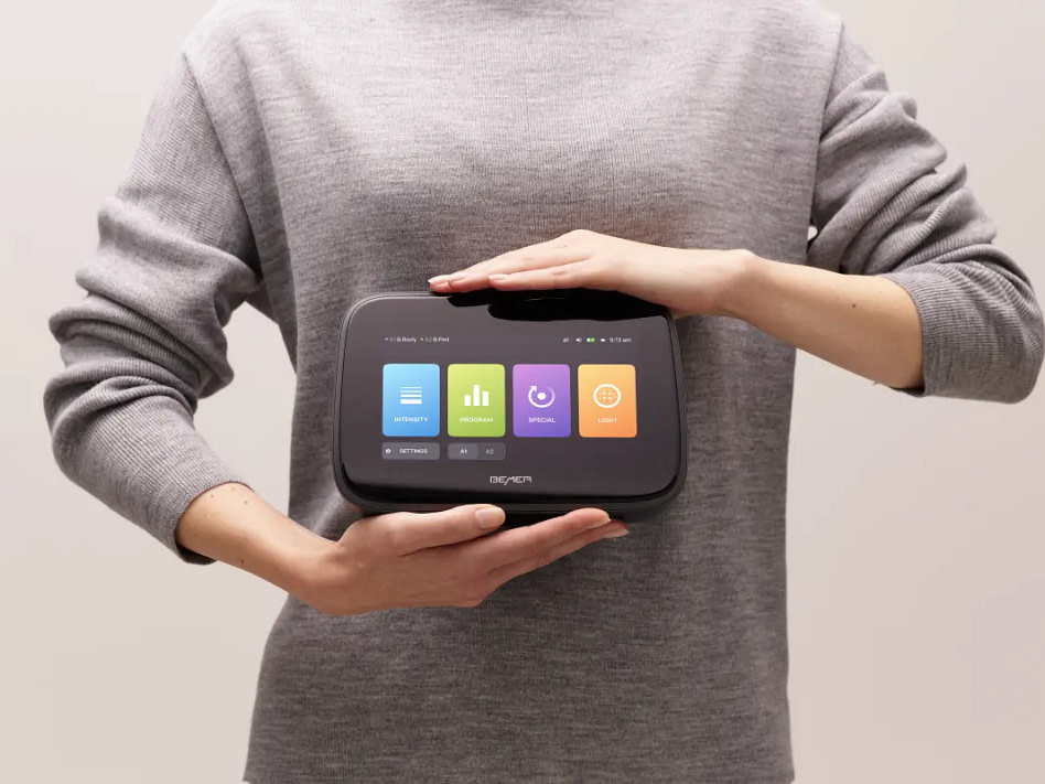 Man holding the bemer evo control unit