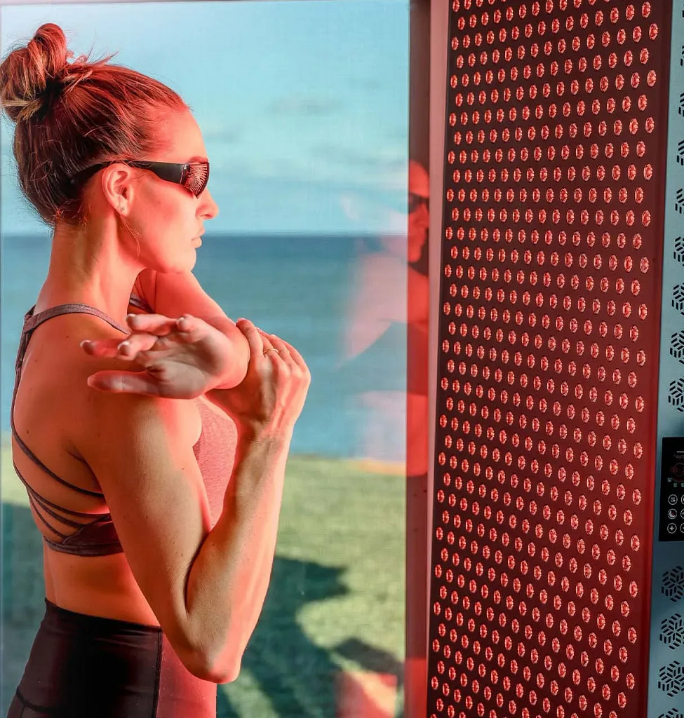 Woman with eye protection glasses in front of Hooga 4500 Red Light Panel