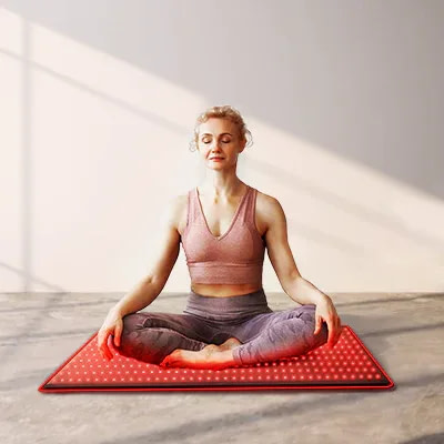 Woman meditating on BestQool LED Mat for combined mindfulness and red light therapy practice