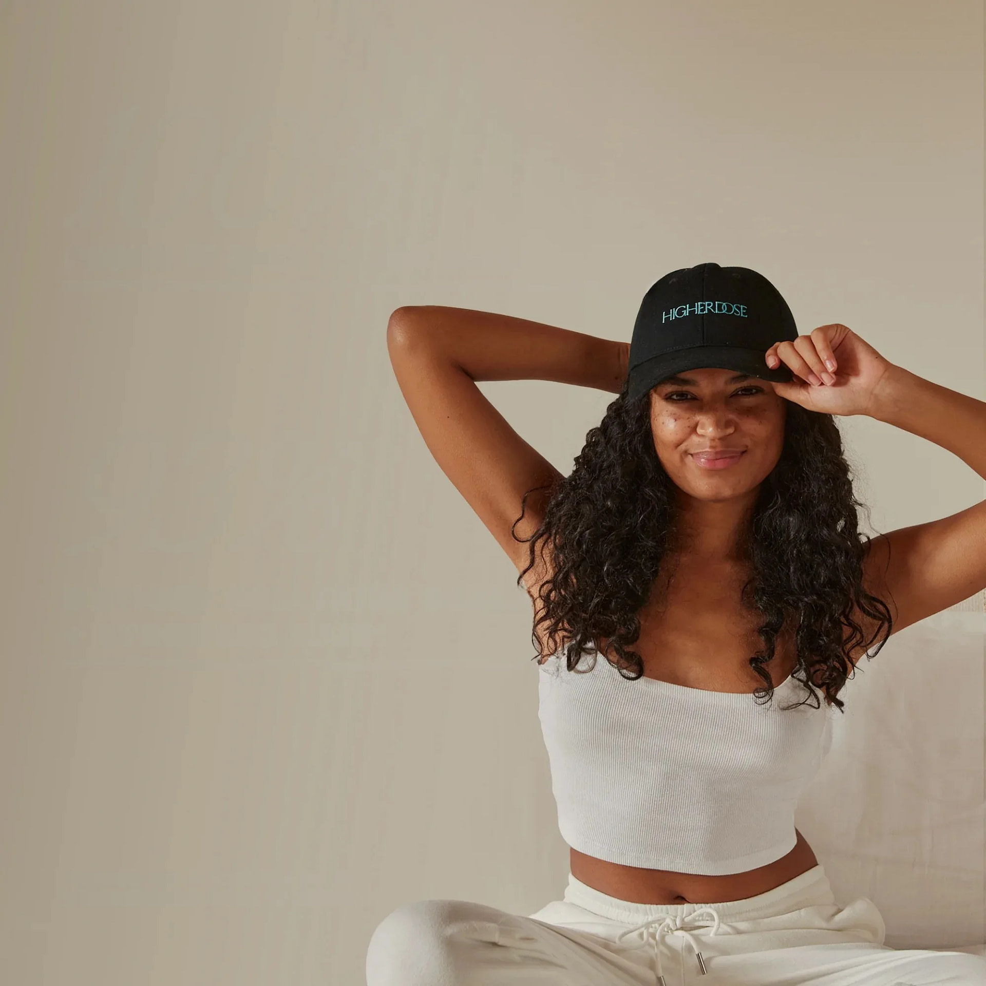 Woman wearing the HigherDose red light hat