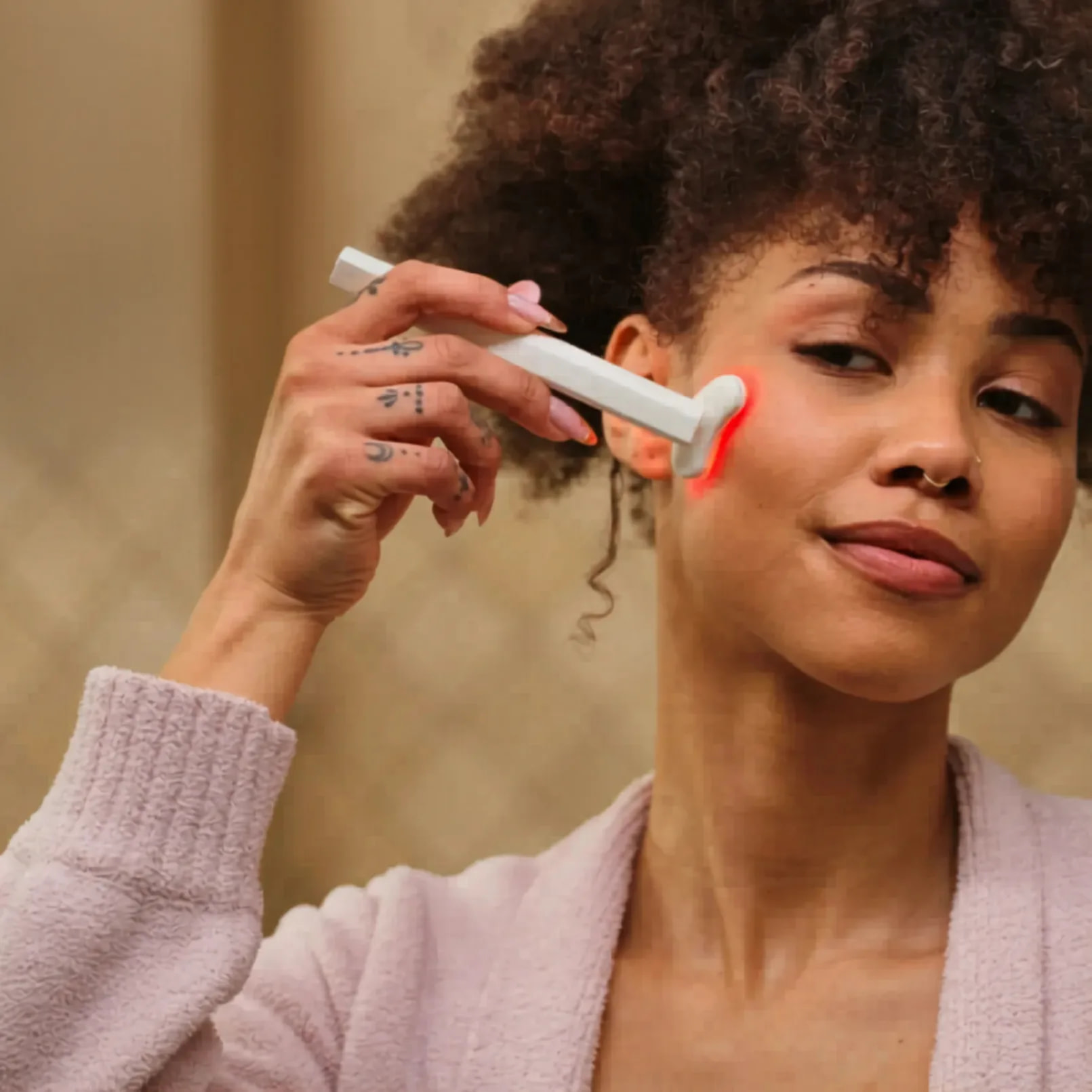 Woman applying Kala Red Light Therapy Wand for precision facial rejuvenation and anti-aging treatment