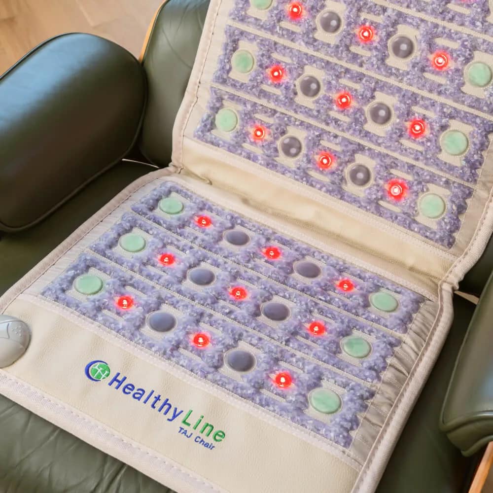 HealthyLine TAJ Chair PEMF Mat elegantly placed on a sofa chair for home therapy