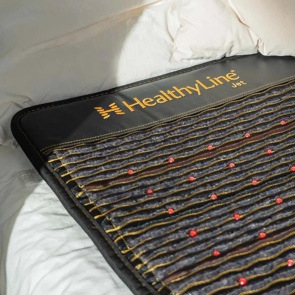 Close-up of HealthyLine JET PEMF Mat showcasing brand logo and gemstone layout