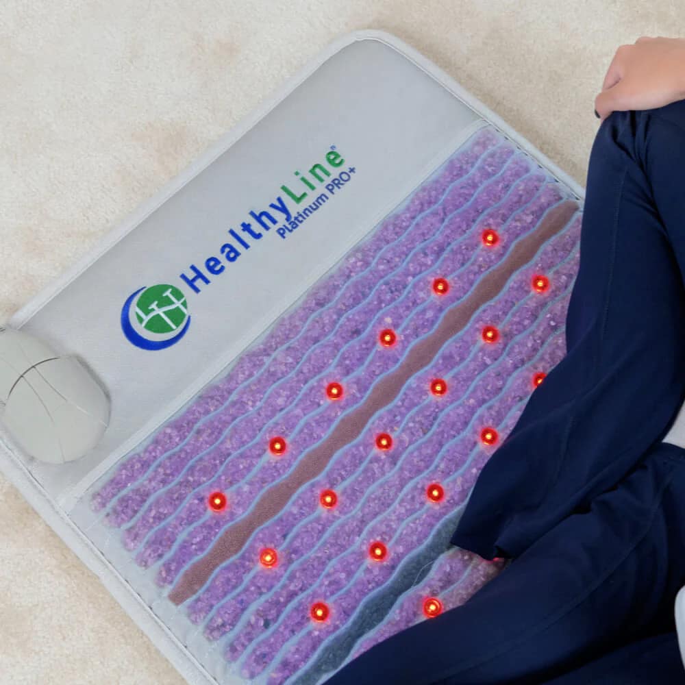 Close-up of HealthyLine logo on PEMF therapy mat designed for chronic pain and inflammation