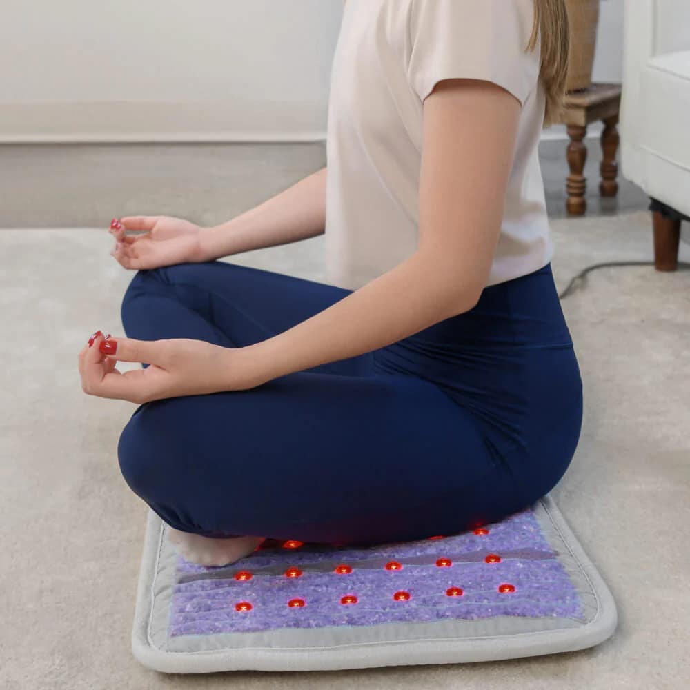 Woman meditating on HealthyLine Platinum PEMF MiniMat, enjoying deep relaxation and therapy