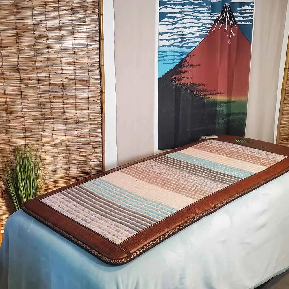 Phymat Chakra PEMF mat placed on bed, ready for home PEMF therapy