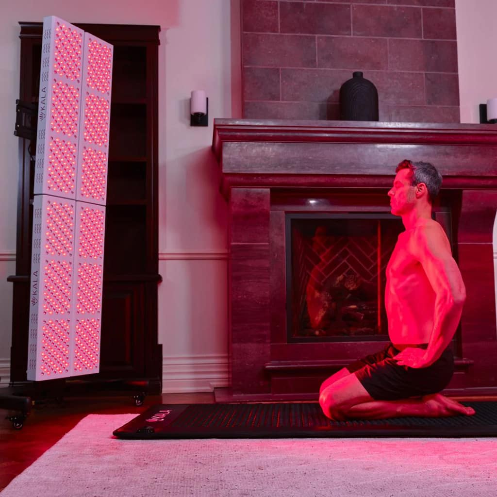 Man meditating during red light therapy session with Kala Elite QUAD on vertical stand