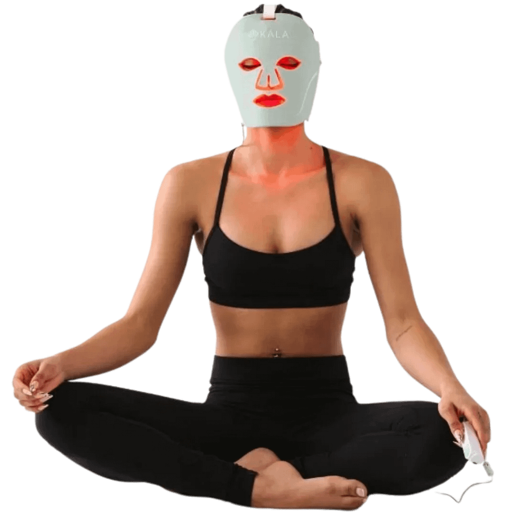Woman using Kala Red Light Therapy Mask during yoga session