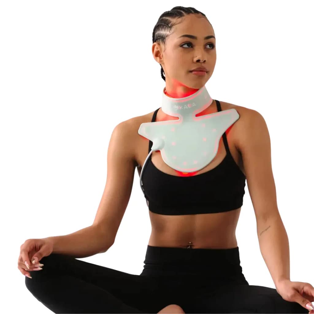 Woman relaxing on floor while using Kala Red Light Therapy Neck Piece for comfortable LED session