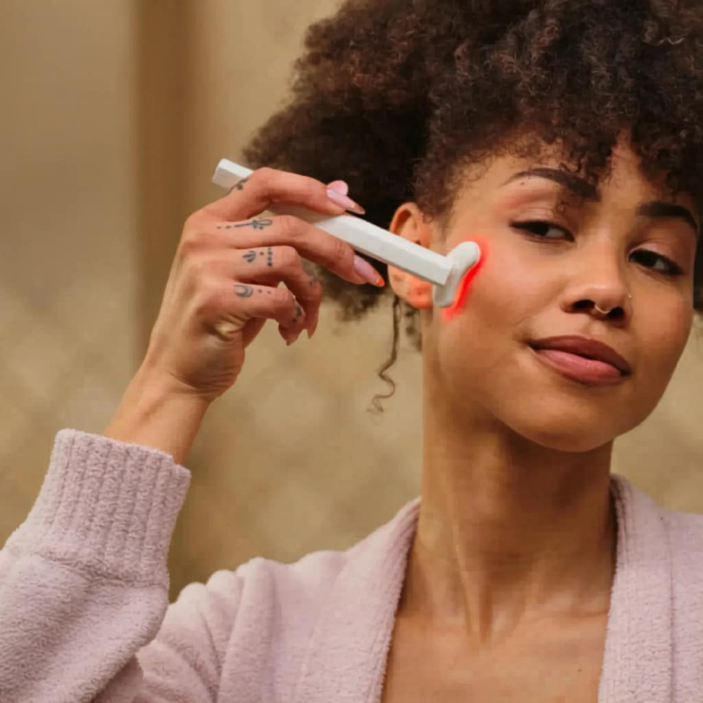 Woman applying Kala Red Light Therapy Wand for precision facial rejuvenation and anti-aging treatment