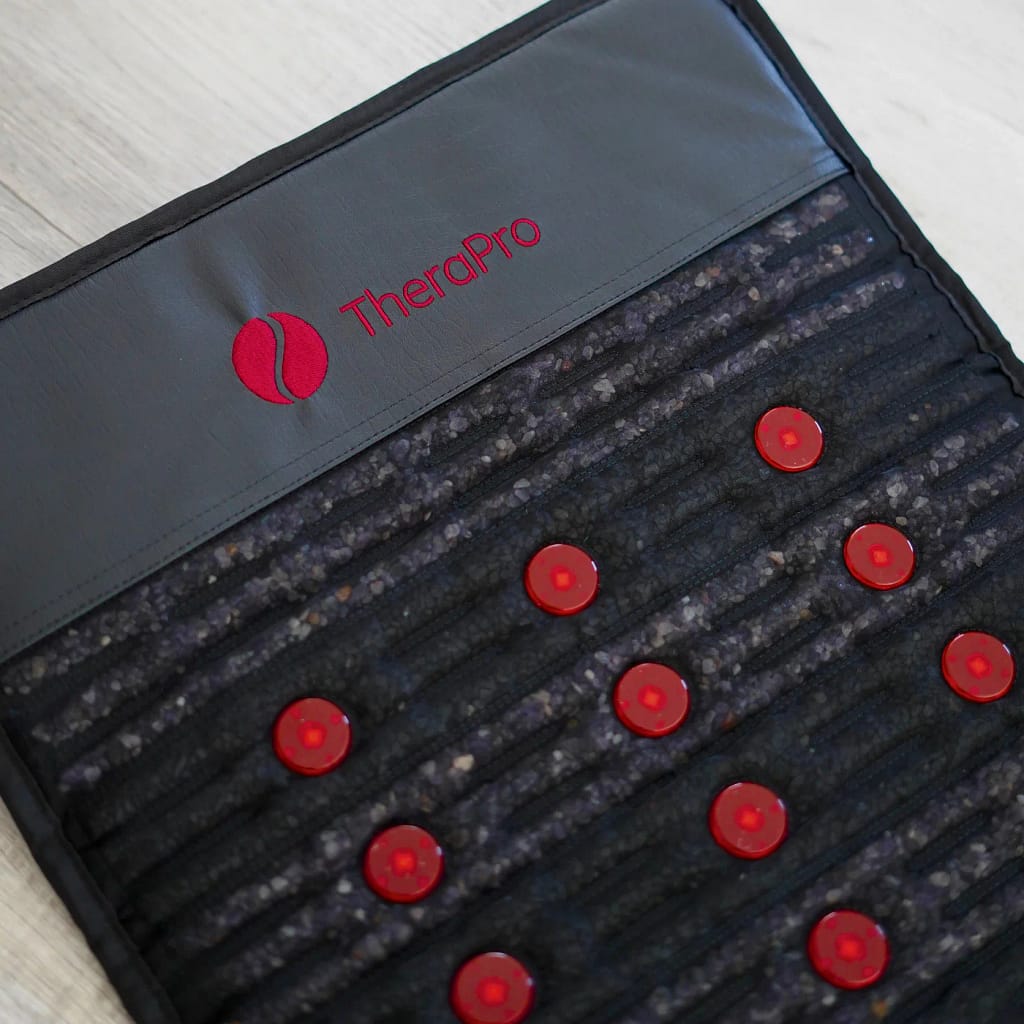 Close-up of Therasage Therapro PEMF MiniMat top surface with logo and gemstone layer