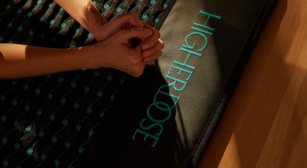 Close-up of Higherdose PEMF mat logo on upper layer of infrared recovery mat