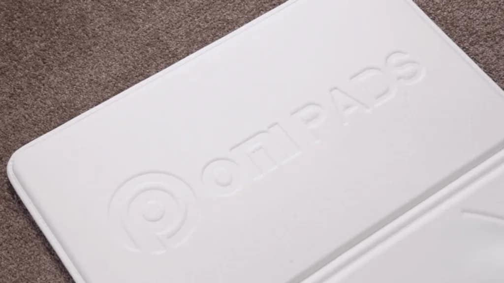 Close-up of OMI PEMF Beyond Mat showcasing the OMI logo on the upper section