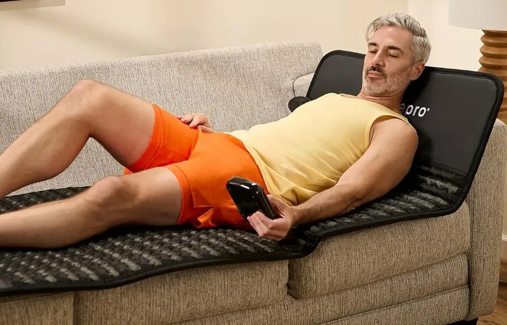 Man Enjoying PEMF And Infrared Heat Therapy On LifePro Infrazen Mat On Couch