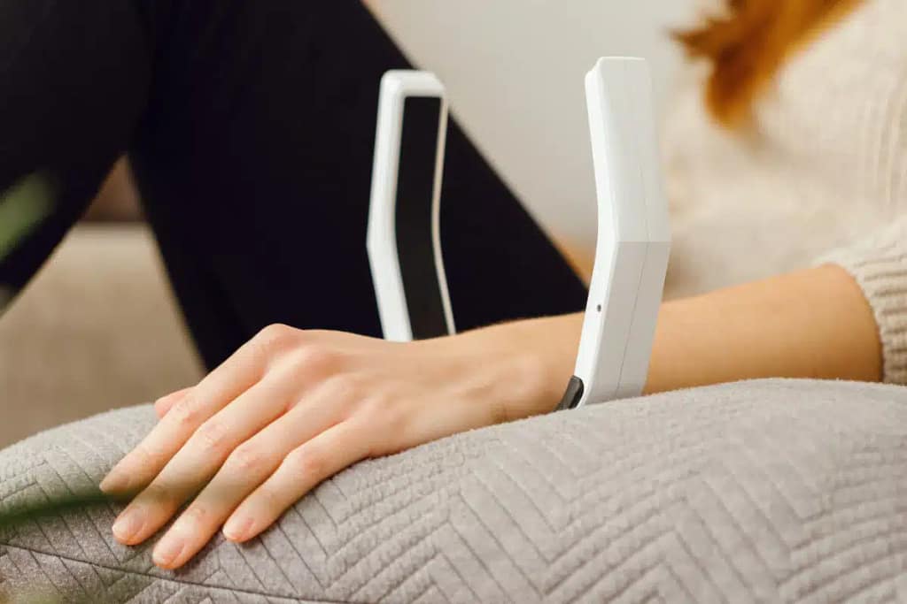 OmniPEMF NeoRhythm PEMF therapy device wrapped on the wrist for stress and pain relief