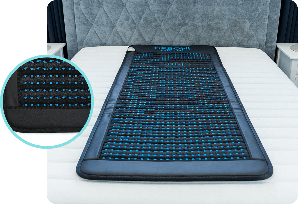 Grooni PEMF mat positioned on bed for comfortable sleep therapy