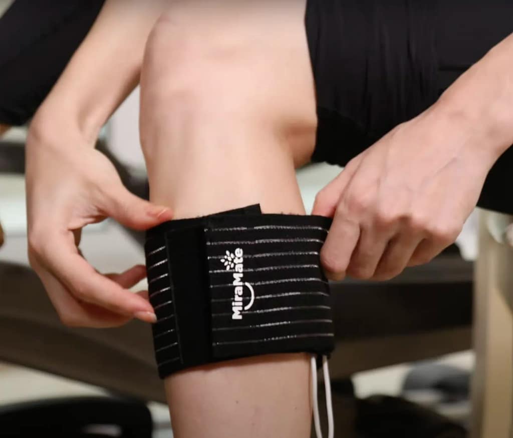 Adjusting PEMF Band on Calf for Muscle Support and Circulation