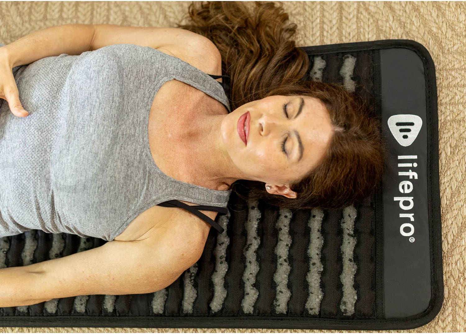 Female Resting On PEMF Mat To Improve Recovery And Sleep