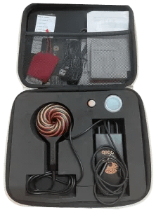 Open vinyl case displaying the Qi Coil Mini and accessories