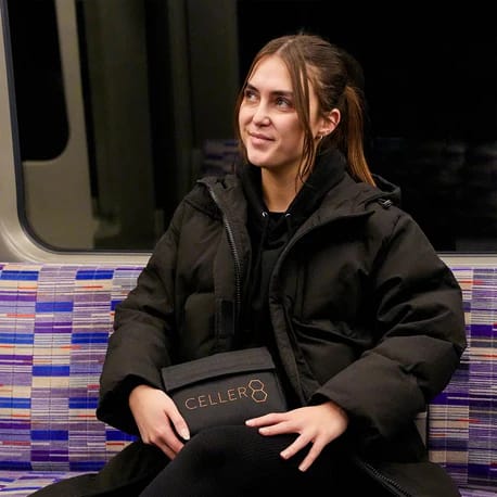 Girl presenting the Celler8 mini travel pouch