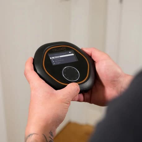 Celler8 PEMF device shown in hands for scale and portability